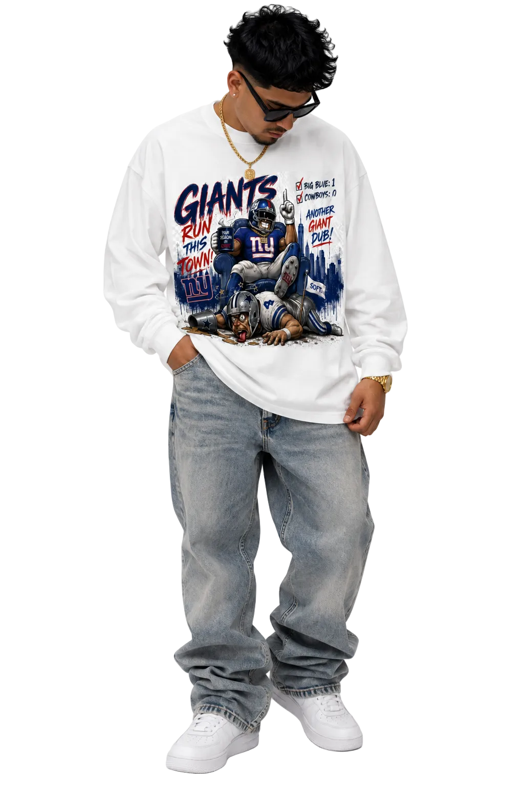A man wearing a white long-sleeve graphic sweatshirt with a New York Giants football print, paired with light-wash jeans and white sneakers, photographed against a plain white background.