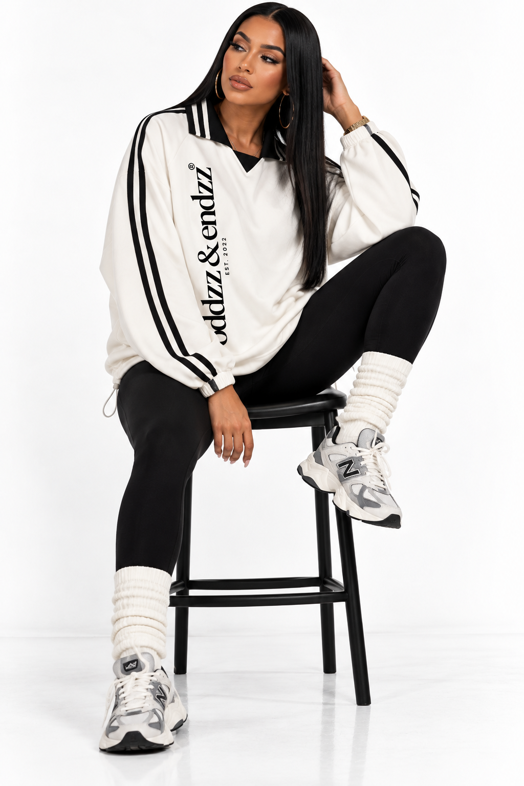 Oddzz & Endzz® cream unisex long sleeve pullover with black contrast collar, sleeve stripes and vertical logo