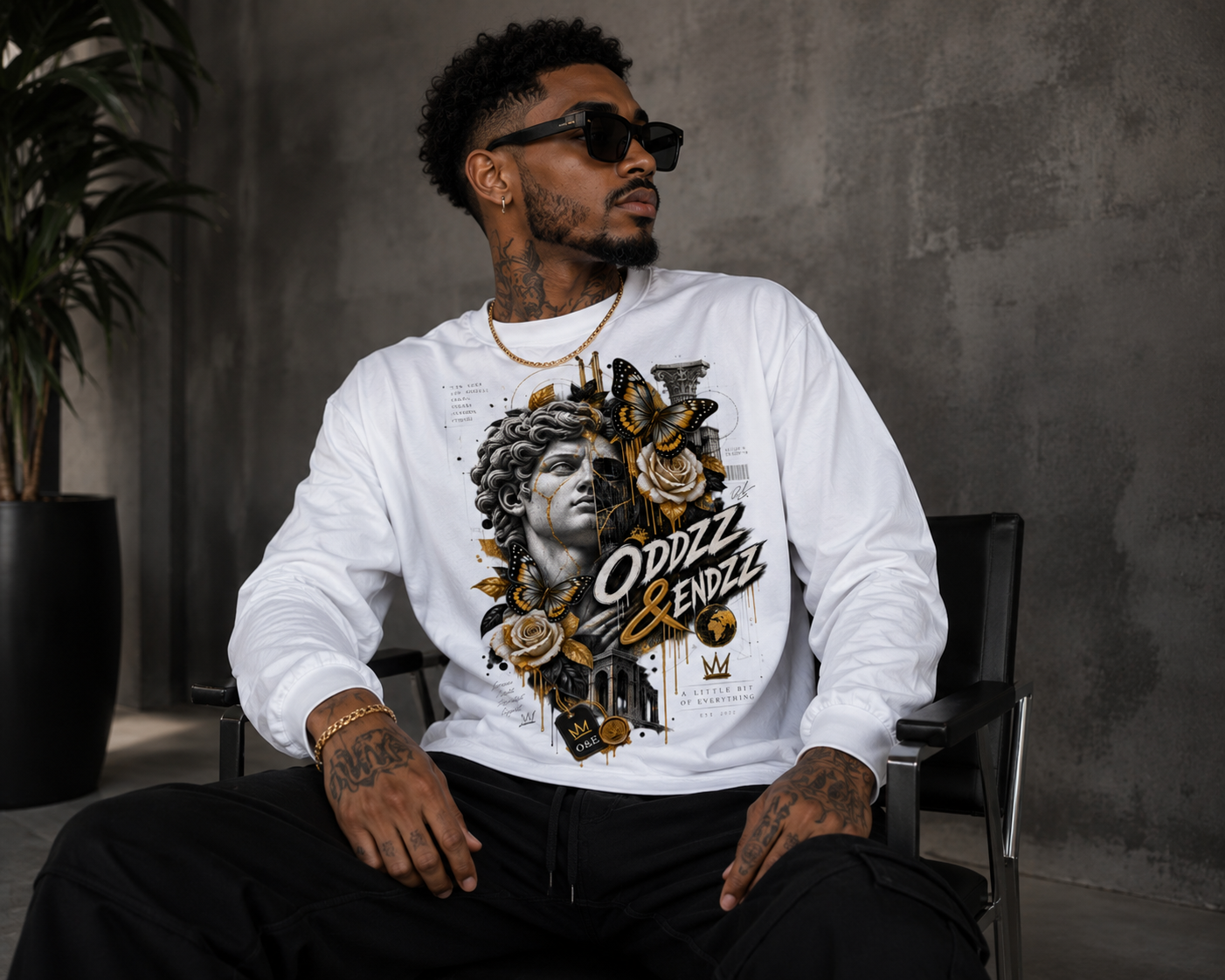 White premium long sleeve t-shirt featuring a Renaissance-inspired statue, architectural blueprint graphics, florals, butterflies, and Oddzz & Endzz® luxury streetwear artwork.