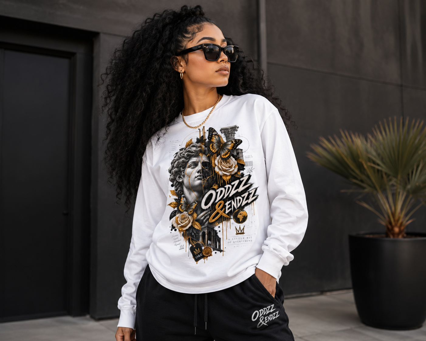 White premium long sleeve t-shirt featuring a Renaissance-inspired statue, architectural blueprint graphics, florals, butterflies, and Oddzz & Endzz® luxury streetwear artwork.