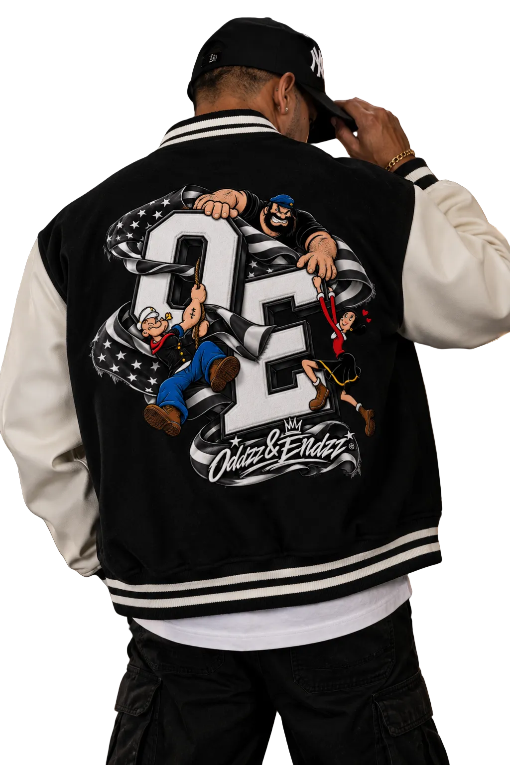 A man viewed from behind wearing a black and white varsity jacket with a large graphic on the back. The graphic features the letters 'OE' in large white numbers, a cartoon cowboy and steer, and the text 'Odizzi & Endz'.